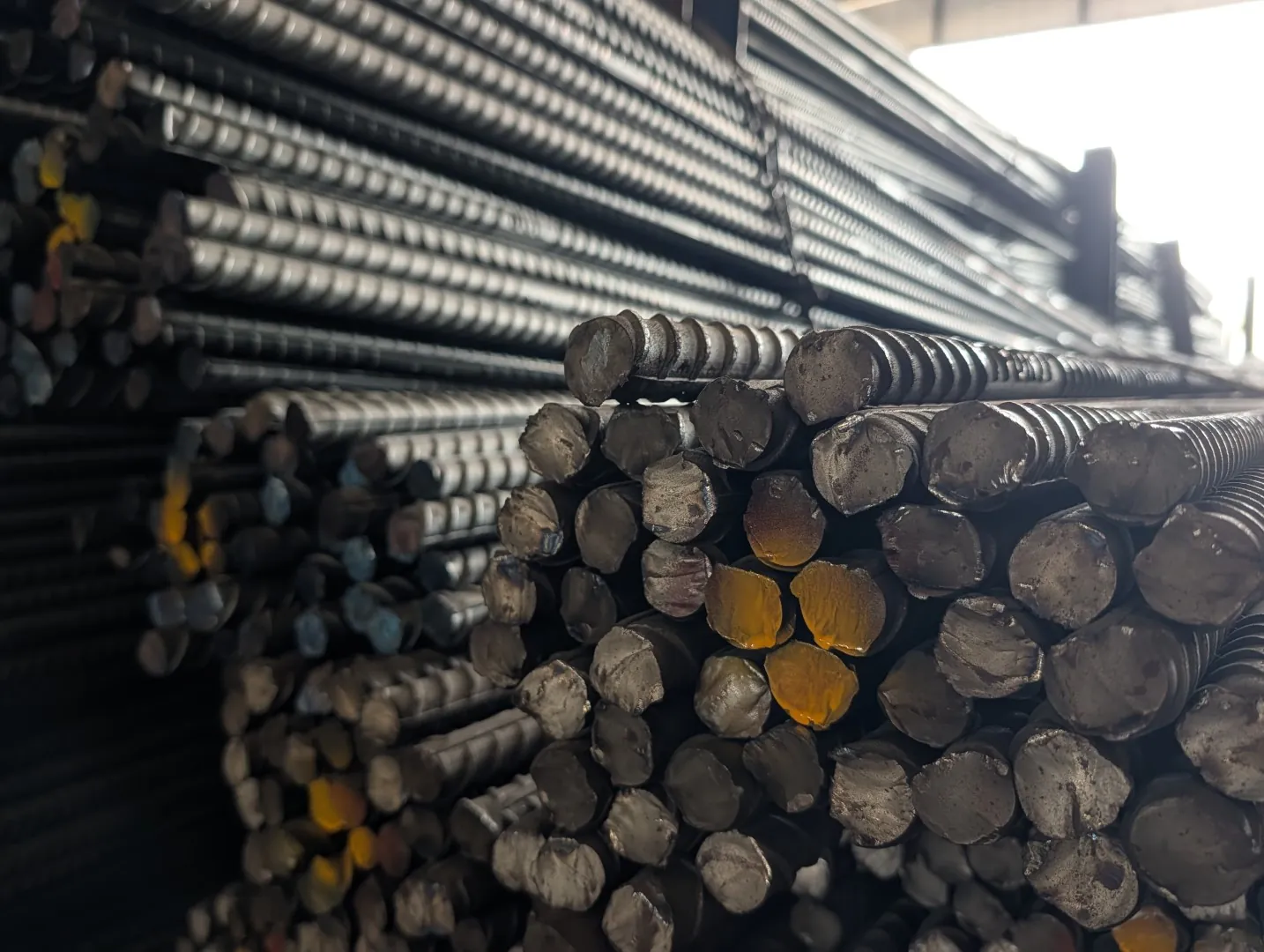 Close-up of cut rebar ends stacked in bundles